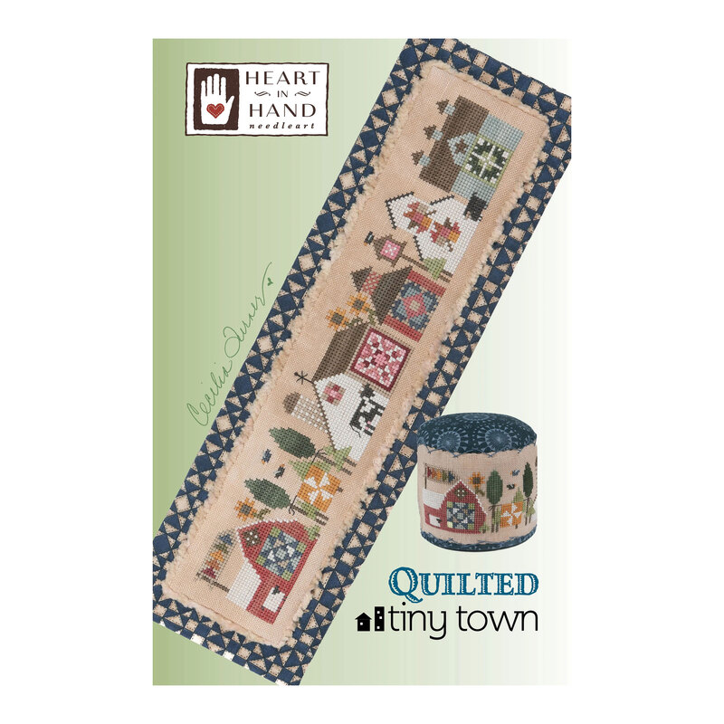 Front cover of the Quilted Tiny Town finished pattern isolated on a green background.