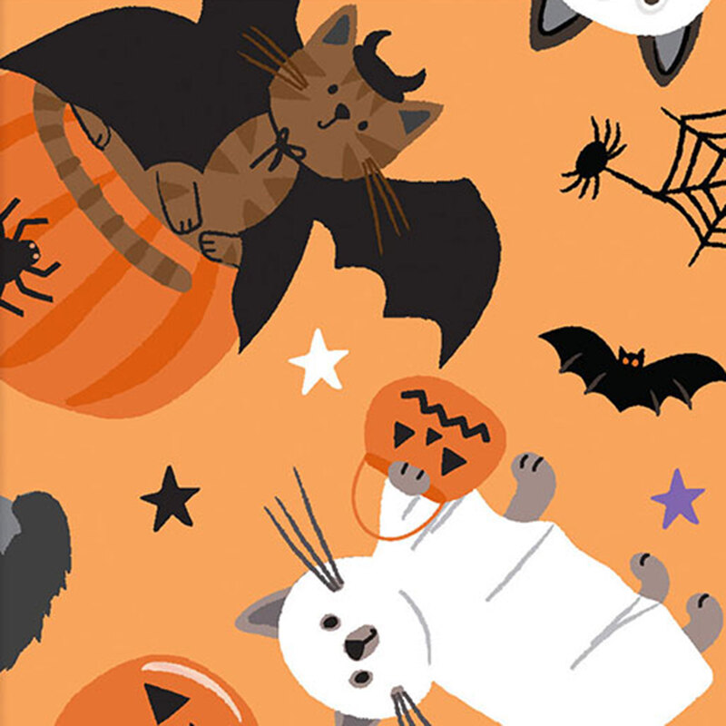 Orange fabric with a tossed pattern of cats dressed in Halloween costumes, surrounded by festive seasonal motifs.