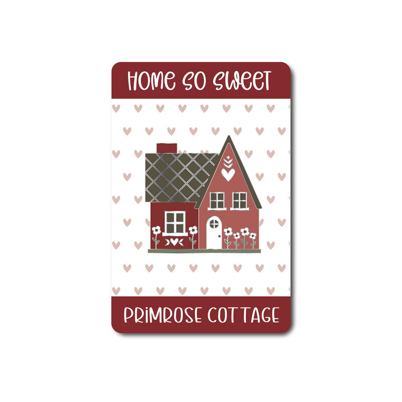 Front of the needle minder showing the full design as a red cottage.