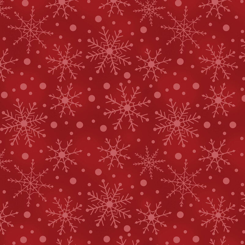 Mottled red fabric with tossed tonal snowflakes and dots.