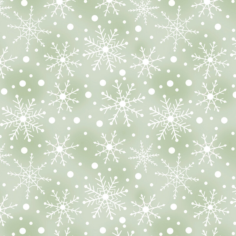 Mottled light sage fabric with tossed white snowflakes and dots.