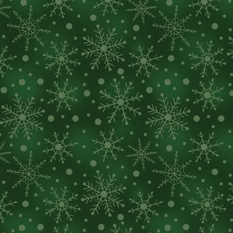Mottled green fabric with tossed tonal snowflakes and dots.