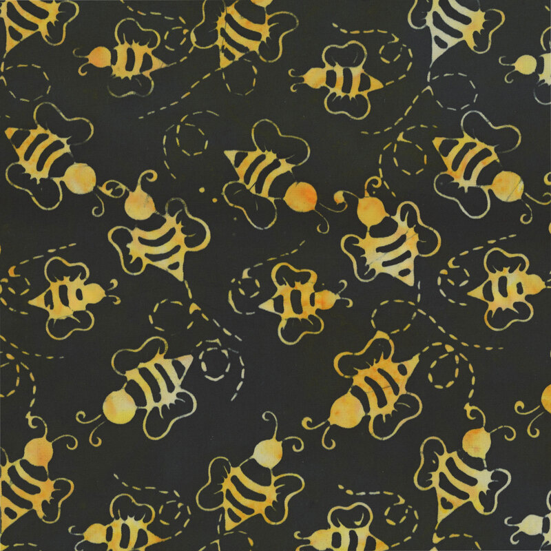 This mottled raven batik fabric features tossed yellow bumble bees. 