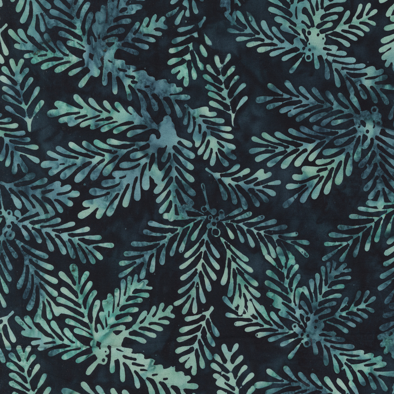 A navy batik fabric with overlapping aqua and teal evergreen branches and needle-like leaves.