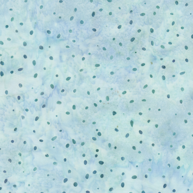 A Pale mist blue batik fabric with scattered blue and teal dots over a mottled background.