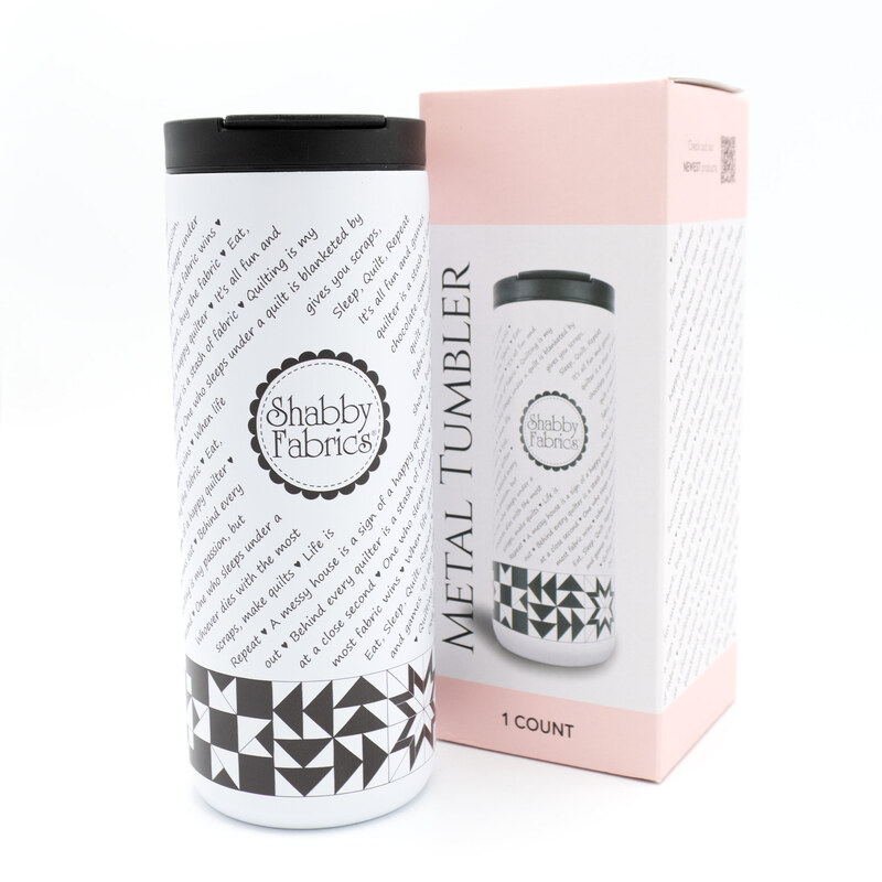 White Shabby Fabrics metal tumbler with black lid beside its pink product box.