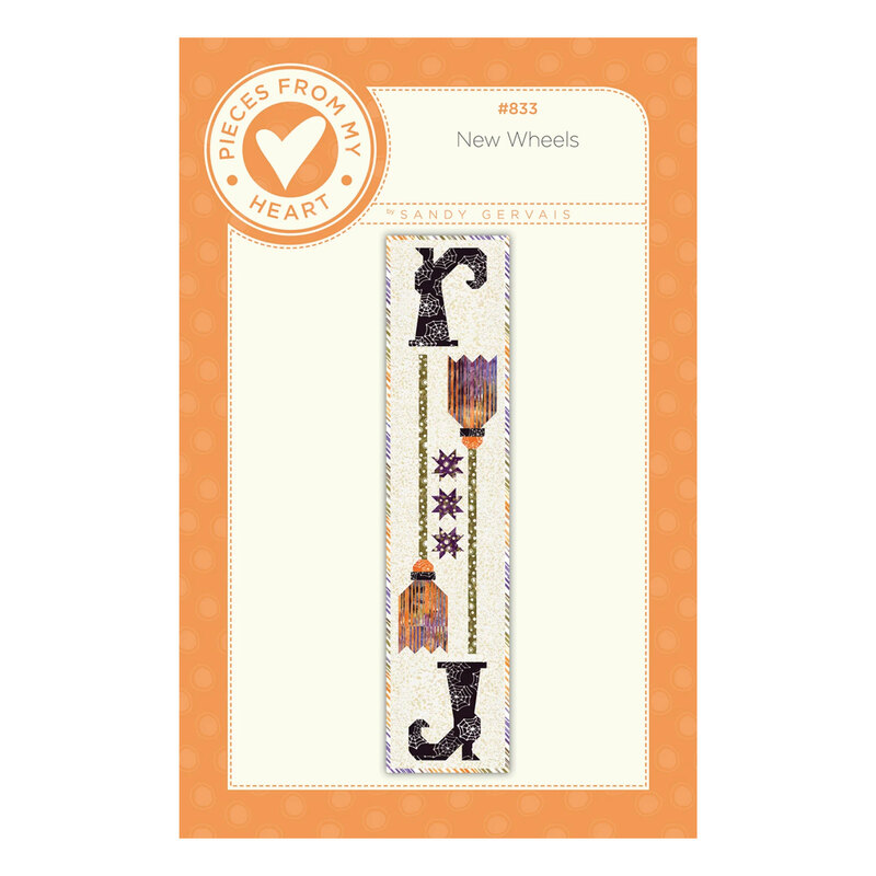 Front of the New Wheels pattern showing a Halloween table runner with pointed witch boots, broomsticks, and star accents on a light background.
