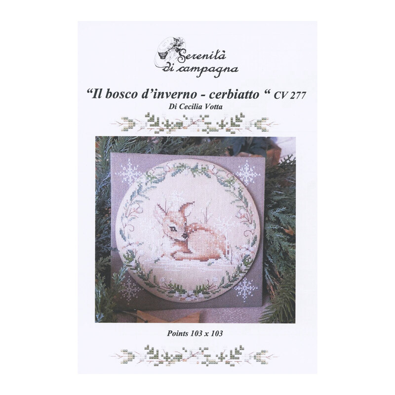 Front cover of the cross stitch pattern with the finished pattern stitched onto a granite-gray finishing board in front of pine boughs.