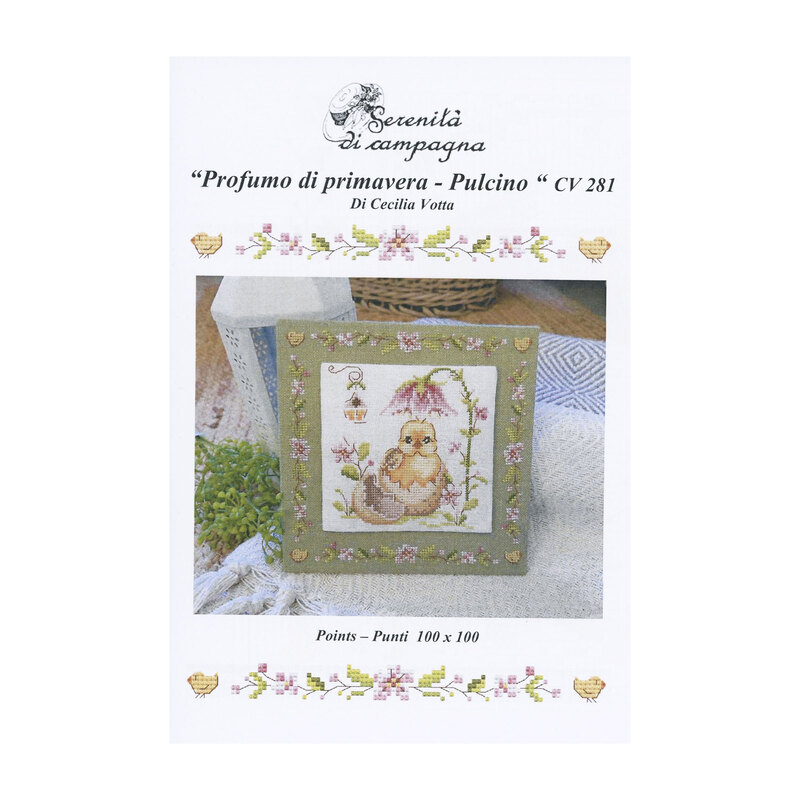 Front cover of the cross stitch pattern with the finished pattern stitched onto a neutral finishing board on a white blanket.