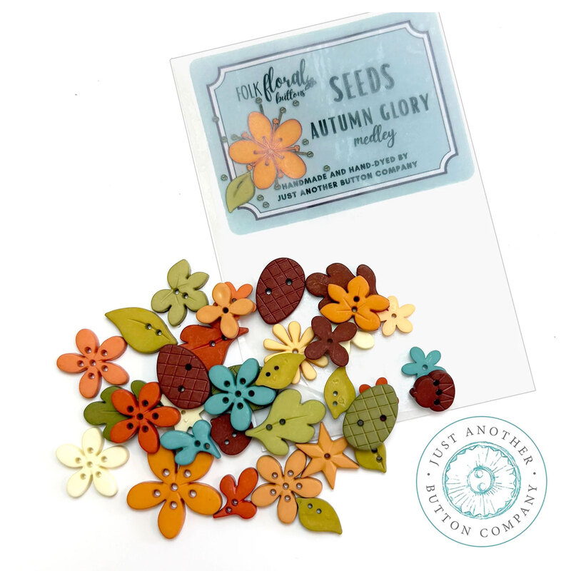 The Autumn Glory button seeds pack featuring an assorted collection of fall-inspired buttons including leaves, flowers, pinecones, and acorns.