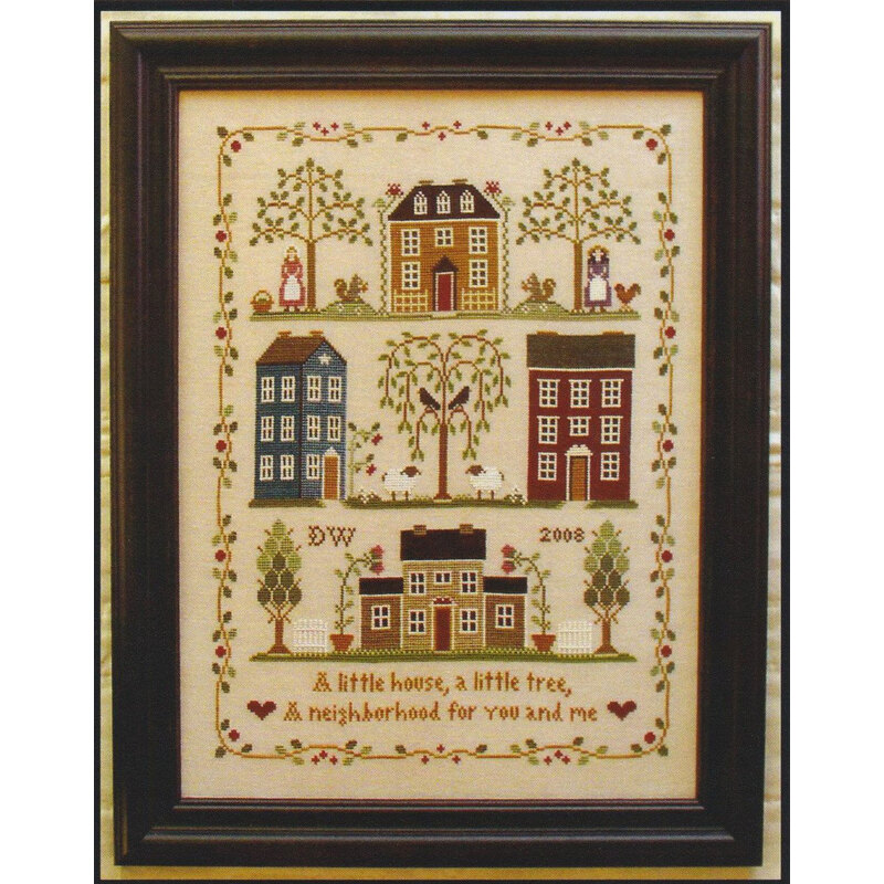 The little house neighborhood cross stitch pattern finished in a wooden frame.