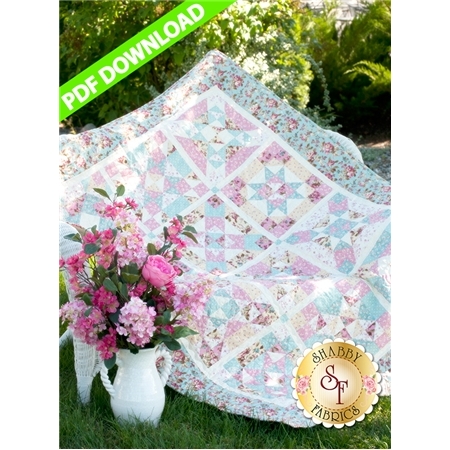 A colorful quilt drapes over grass, next to a white vase filled with pink flowers, with a PDF DOWNLOAD banner on the top left corner.