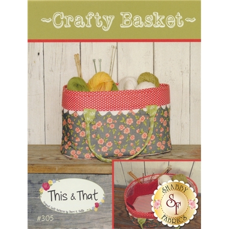 A fabric basket filled with colorful yarn and knitting needles, surrounded by a floral pattern and a red polka dot trim. The design features a top text header stating Crafty Basket and a logo for Shabby Fabrics.