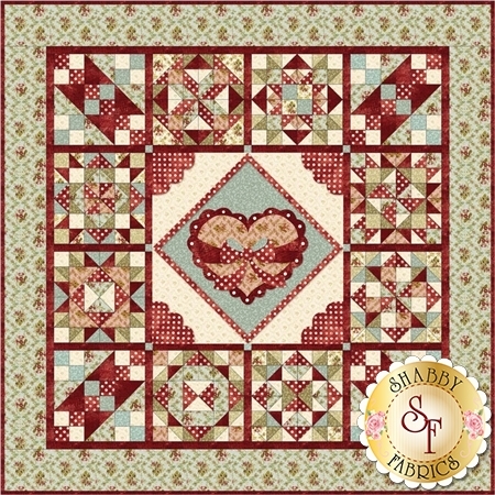 Image of the finished quilt with a large central heart appliqued on shabby chic green, red, blue and cream patchwork.