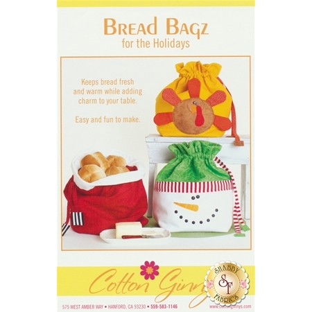 A promotional image for Bread Bagz for the Holidays featuring three decorative bread bags: one resembling a turkey, one in a snowman design, and one in a festive red color. The text highlights that these bags keep bread fresh and add charm to the table, stating they are easy and fun to make.