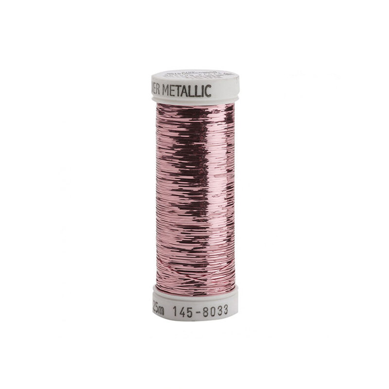 A spool of pink metallic sewing thread with a white label.