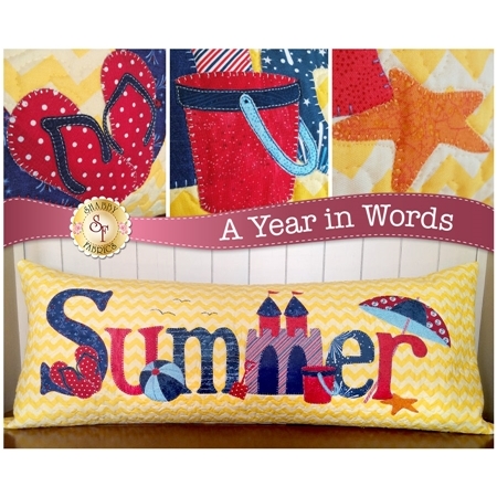 Kit for July A Year In Words pillow reading Summer with a sandcastle and yellow beach.