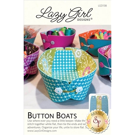 A colorful sewing pattern titled Button Boats by Lazy Girl Designs, featuring a variety of small fabric storage baskets in vibrant colors and patterns. The design includes buttons and folds for easy assembly. The packaging includes information for using the pattern to create the baskets.