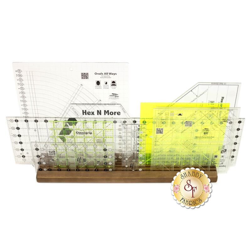 The Omnigrid Wooden Ruler Rack holding several sets of rulers, showing the layering that you can achieve and space saved with this rack.