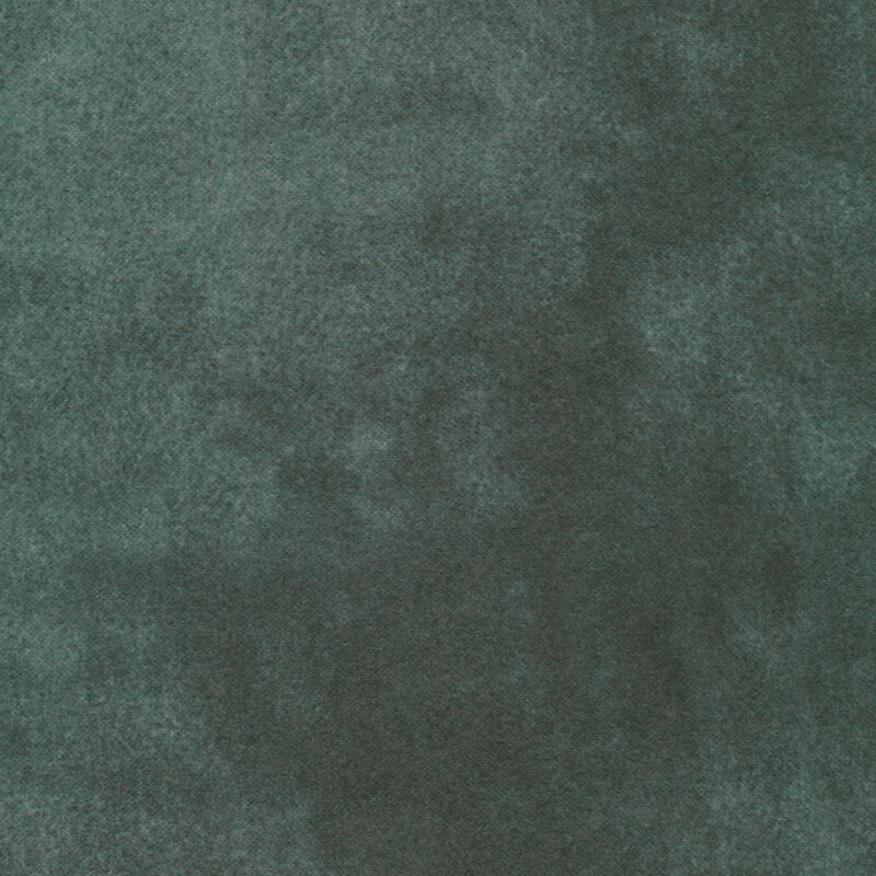 A textured surface in a deep green color, resembling a soft fabric or suede.