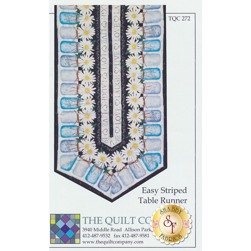 A colorful quilt pattern featuring a table runner design with blue and white striped sections and yellow daisies along the edges. The text reads Easy Striped Table Runner and includes a logo for the quilt company.