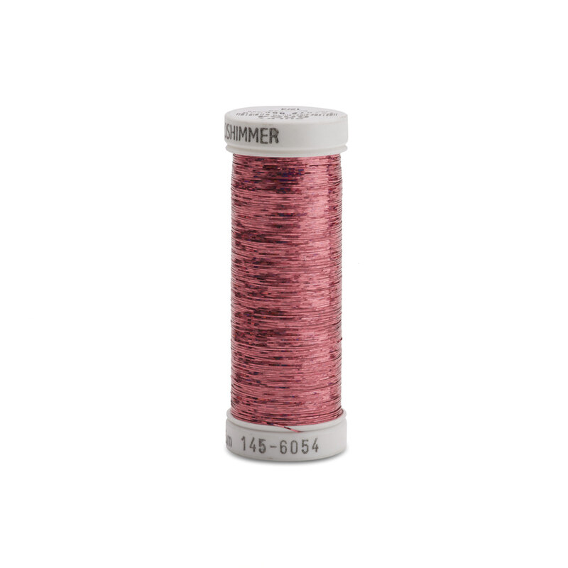 A spool of pink metallic sewing thread with a white label.