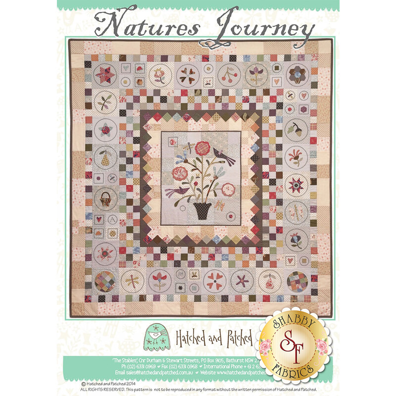 The front of the Nature's Journey pattern showing the finished quilt on a white and aqua background.