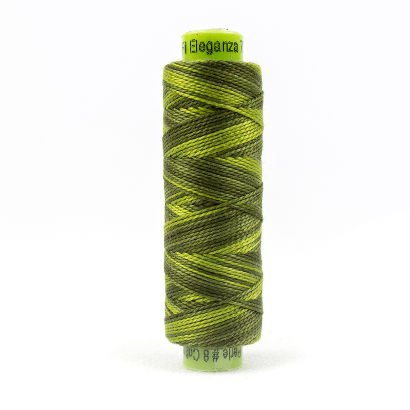 A spool of WonderFil Eleganza EZM903 Up A Tree thread on a white background