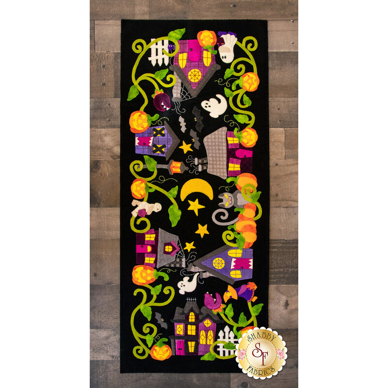 Spooky street with haunted houses, mummies, ghosts, and jack o' lanterns.