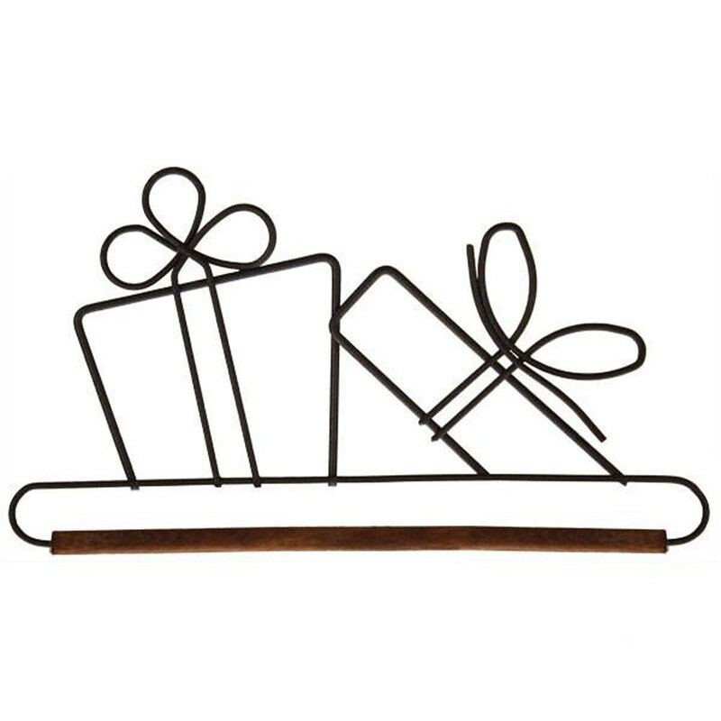 Black metal wall art depicting two gift boxes with bows, mounted on a wooden bar.