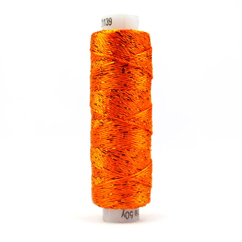 A spool of WonderFil Dazzle 1139 - Golden Poppy thread on a white background