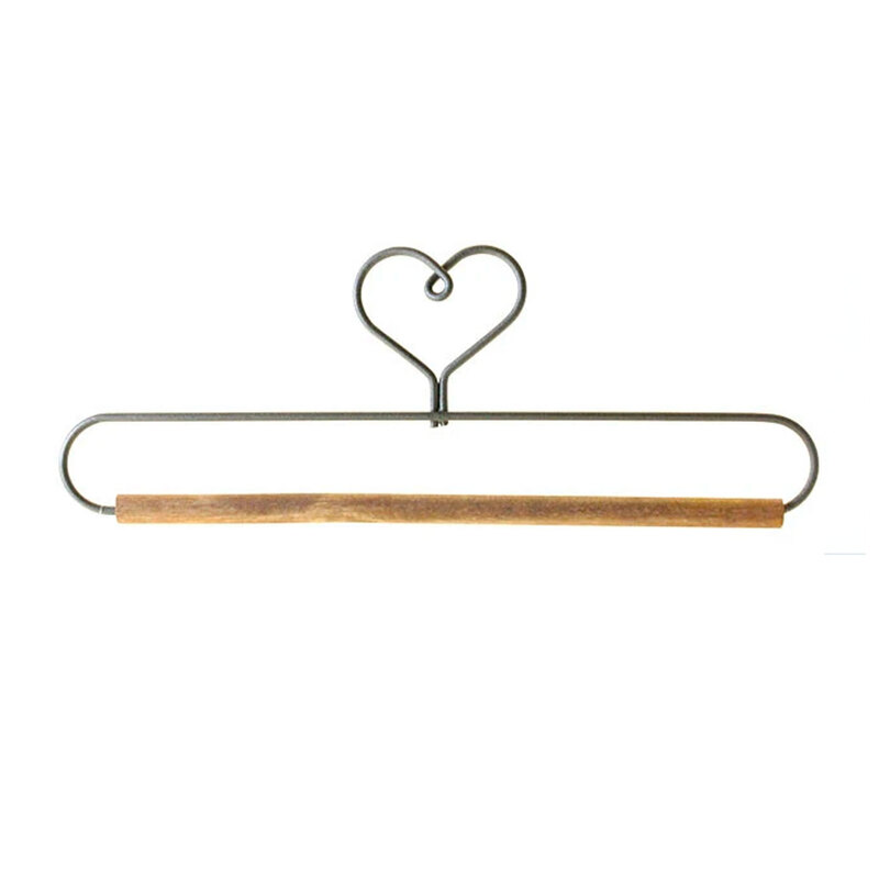 Metal wall hanger with a heart-shaped top and wooden bar for hanging items.