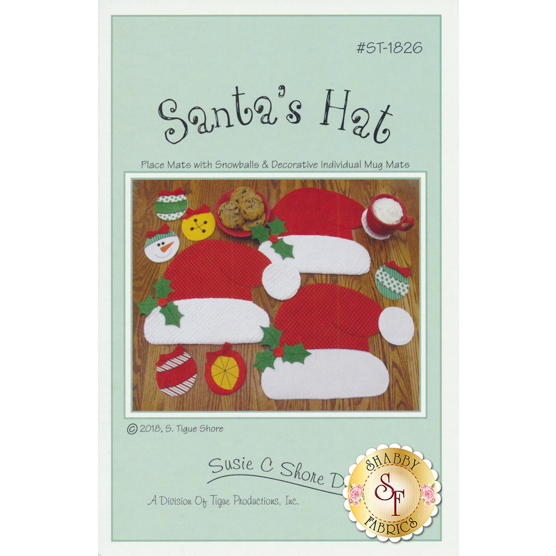 A craft pattern cover titled Santa's Hat, featuring designs for place mats and individual mug mats. The background shows several red and white Santa hats with holiday-themed decorations like snowflakes and ornaments. The design is by Susie C. Shore Designs, dated 2018.