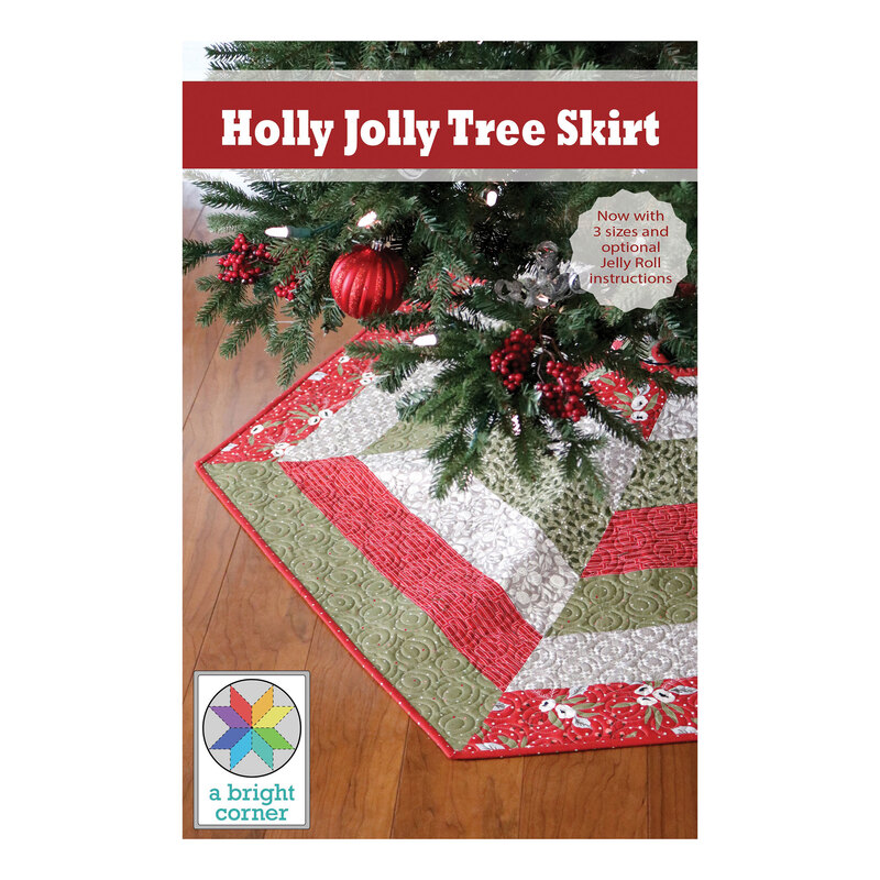Front cover of the pattern, a decorative tree skirt named Holly Jolly Tree Skirt, featuring a patchwork design in red, green, and white geometric patterns. The skirt is placed beneath a Christmas tree with twinkling lights.