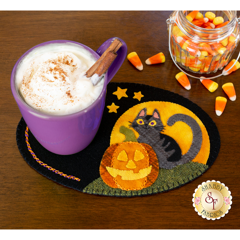 Halloween themed mug mat with a cup of cocoa resting on top