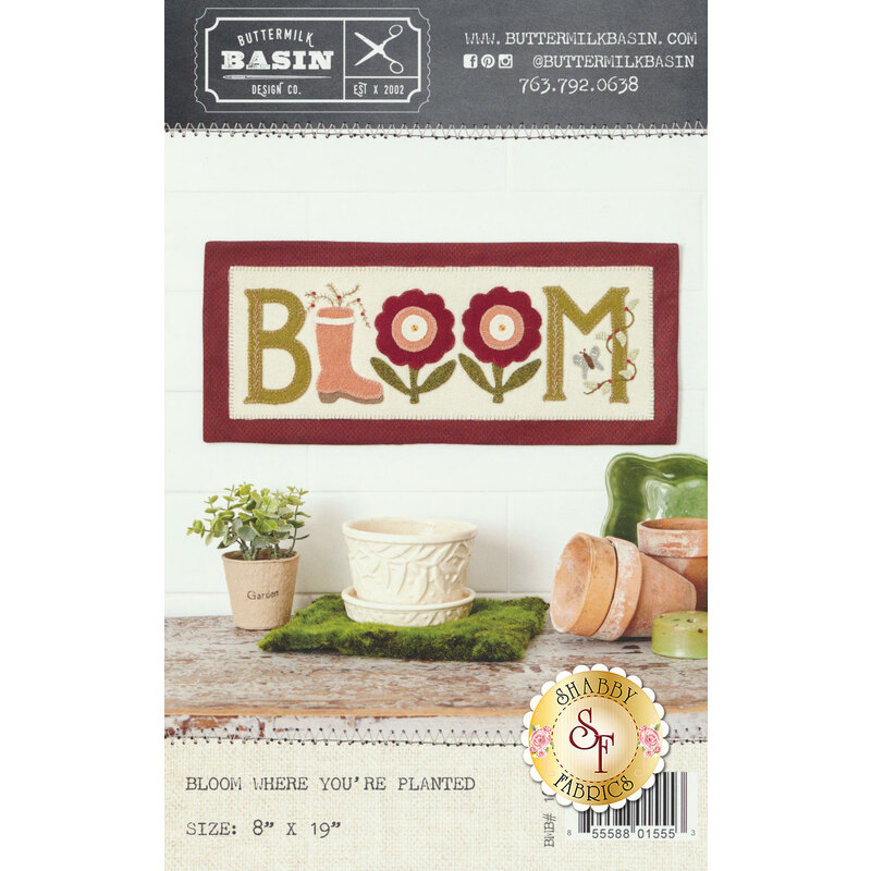 The front cover of the Bloom Where You're Planted Pattern showing the finished mat with the word BLOOM, replacing the L with a rainboot, and the double O's with large flowers.