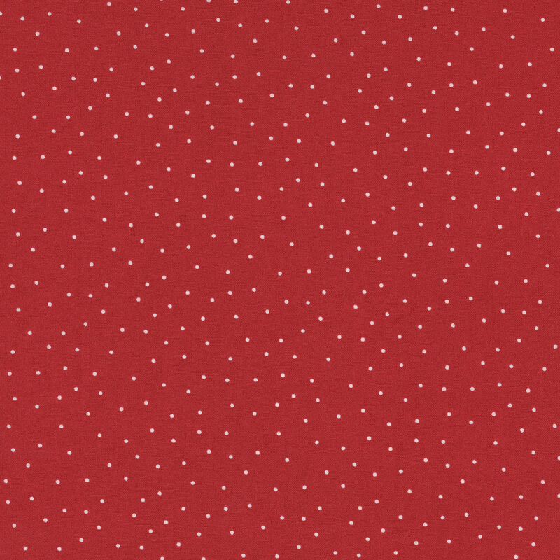 fabric featuring a brick red background with scattered small white dots