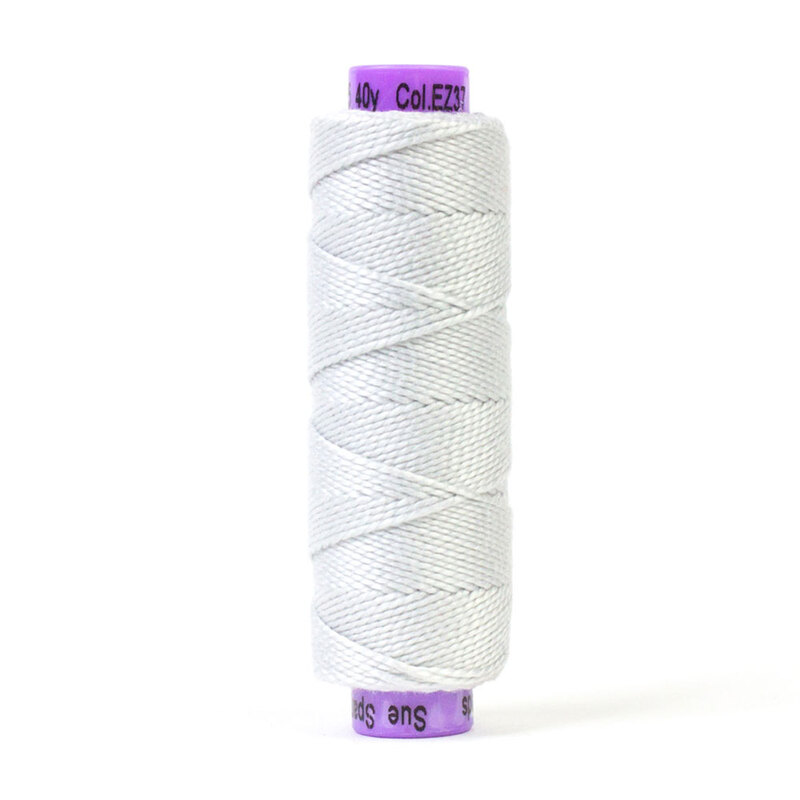 A spool of WonderFil Eleganza EZ37 Cool Ashes thread on a white background