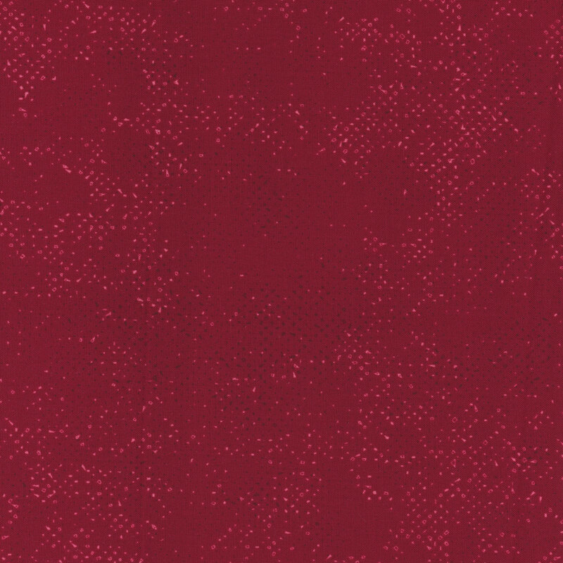 Textured garnet red fabric with a pattern of small tonal speckles