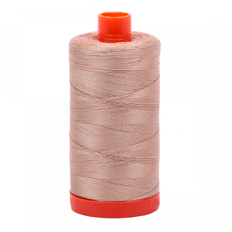 A spool of Aurifil 2314 - Beige thread on a white background