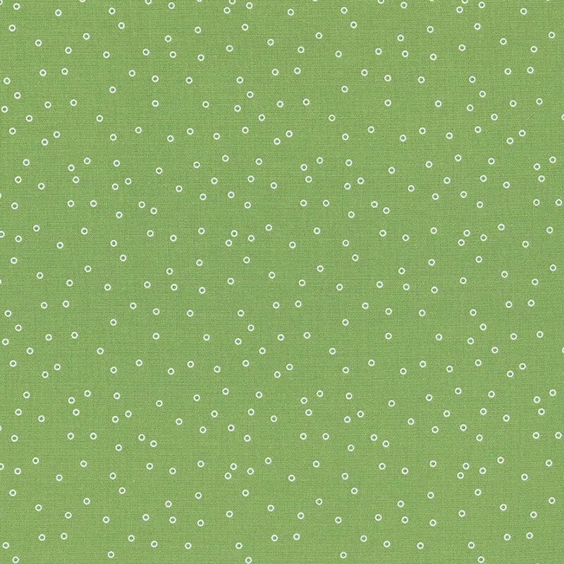 Green fabric with a scattered pattern of small white dots.