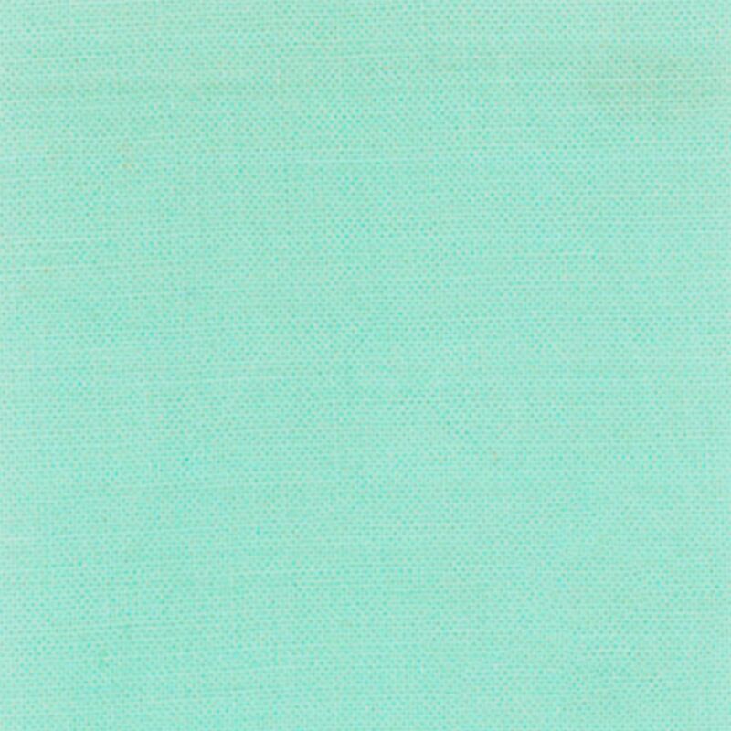 A slight light teal solid cotton fabric