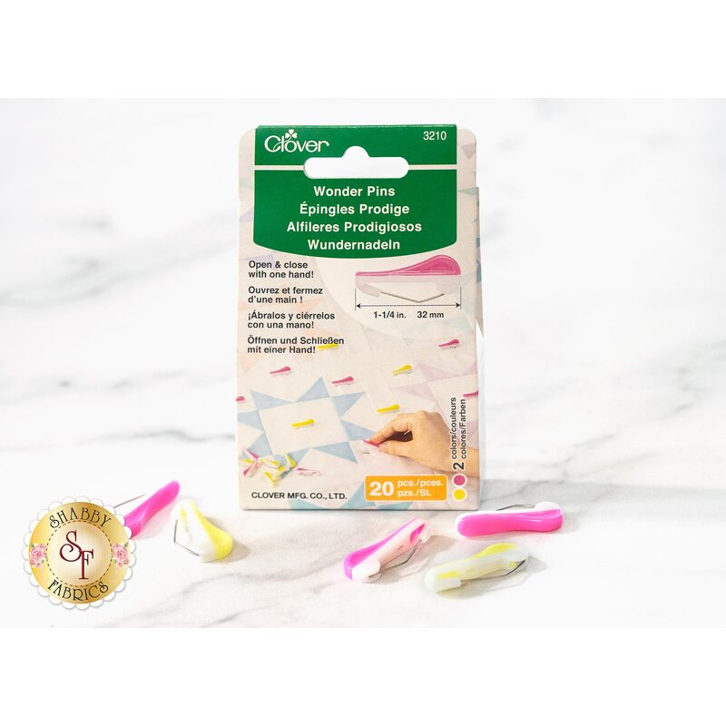 Package of Clover Wonder Pins with colorful pins on a marble surface, labeled for sewing use.