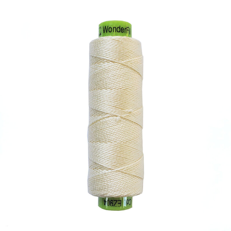 A spool of WonderFil Eleganza EZ904 Cream thread on a white background