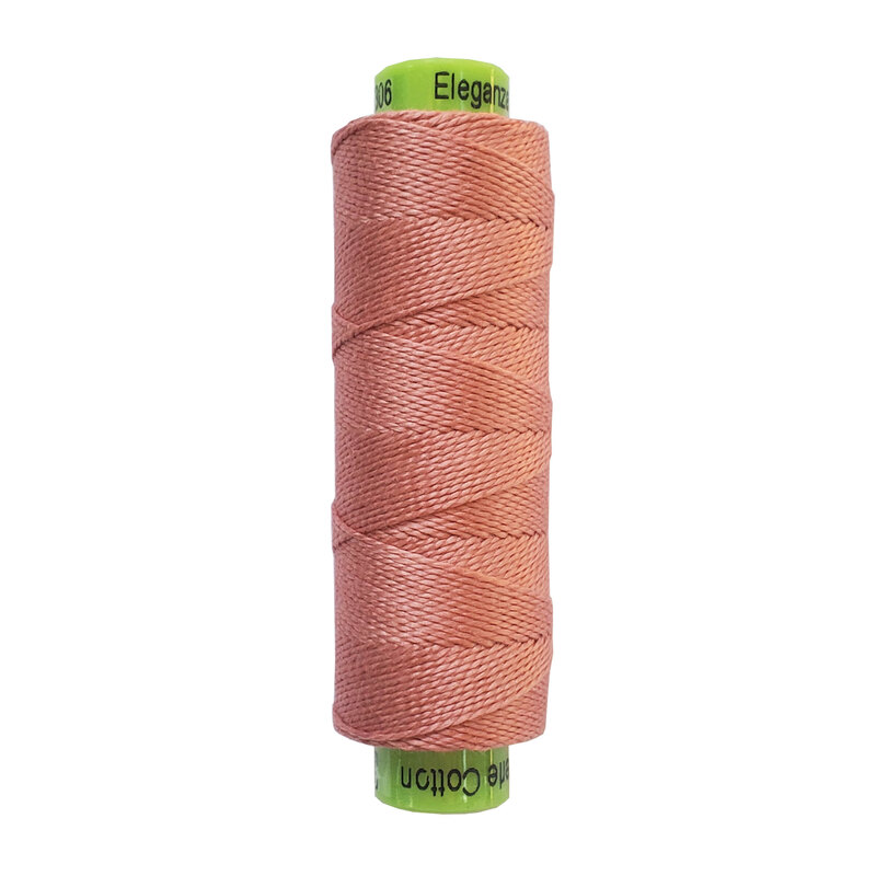 A spool of WonderFil Eleganza EZ306 Rosy Tan thread on a white background