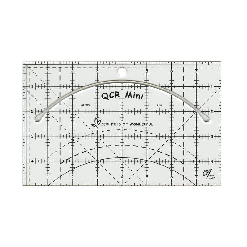 Clear rectangular quilting ruler with measurement markings and a long curved cutting slot for trimming and shaping fabric pieces.