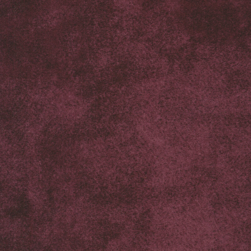 A textured fabric featuring a deep burgundy color with subtle variations and a soft appearance.