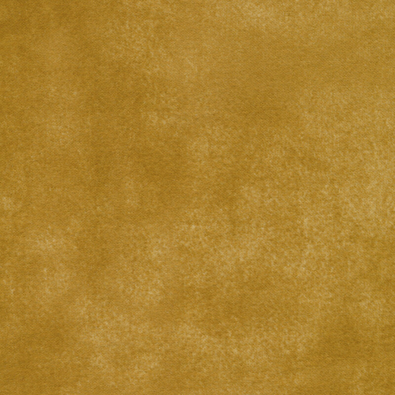 A textured fabric surface in a warm golden hue.