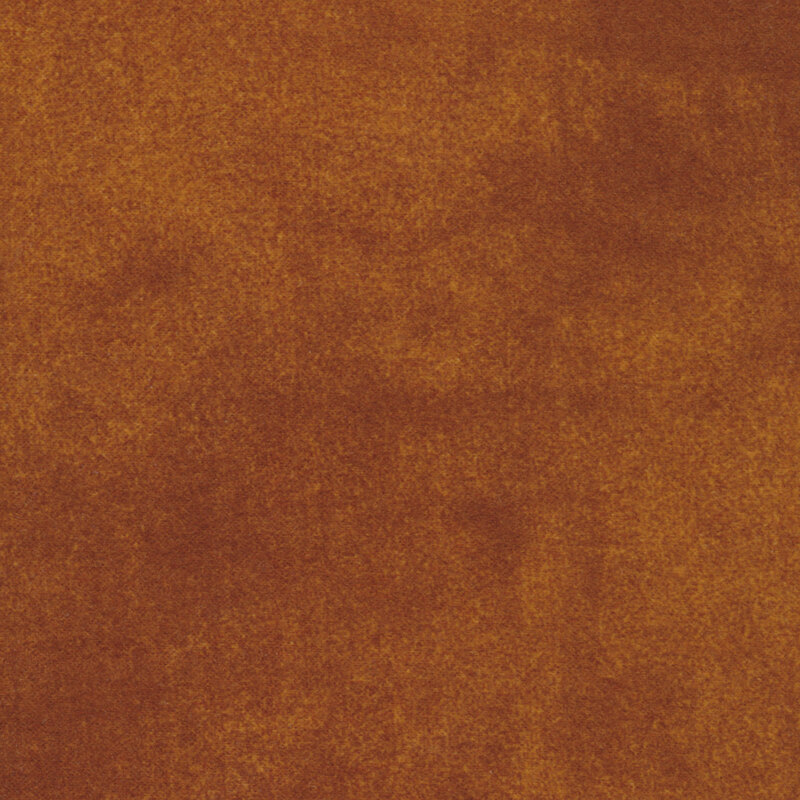 A solid, textured fabric surface in warm brown shades.