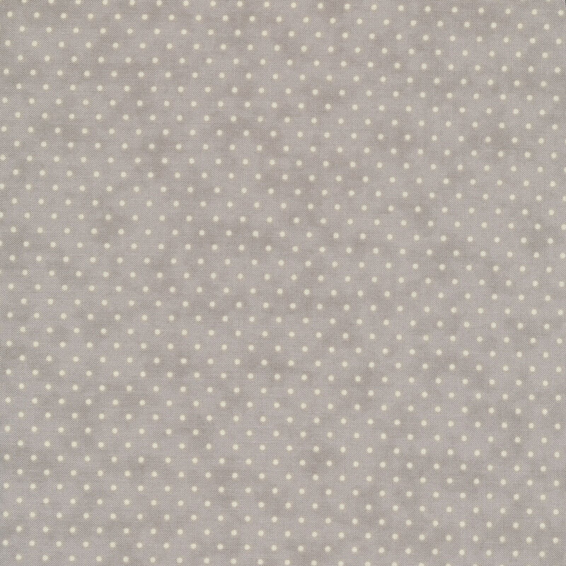 mottled gray fabric with small white polka dots throughout